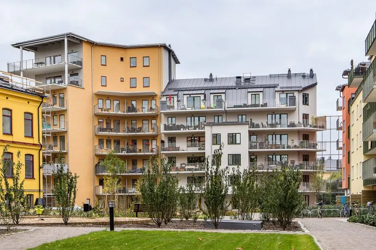 Lägenhetskomplex med stående­fals plåttak, stuprör och plåtförklädnad